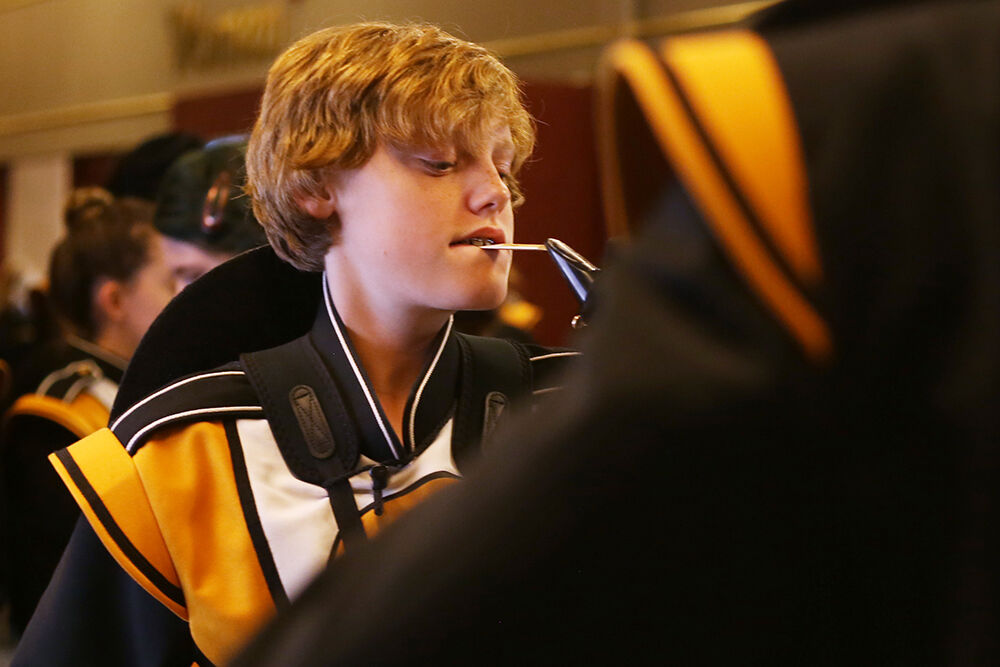 Logan Jordahl warms up his reed as he and the rest of the band